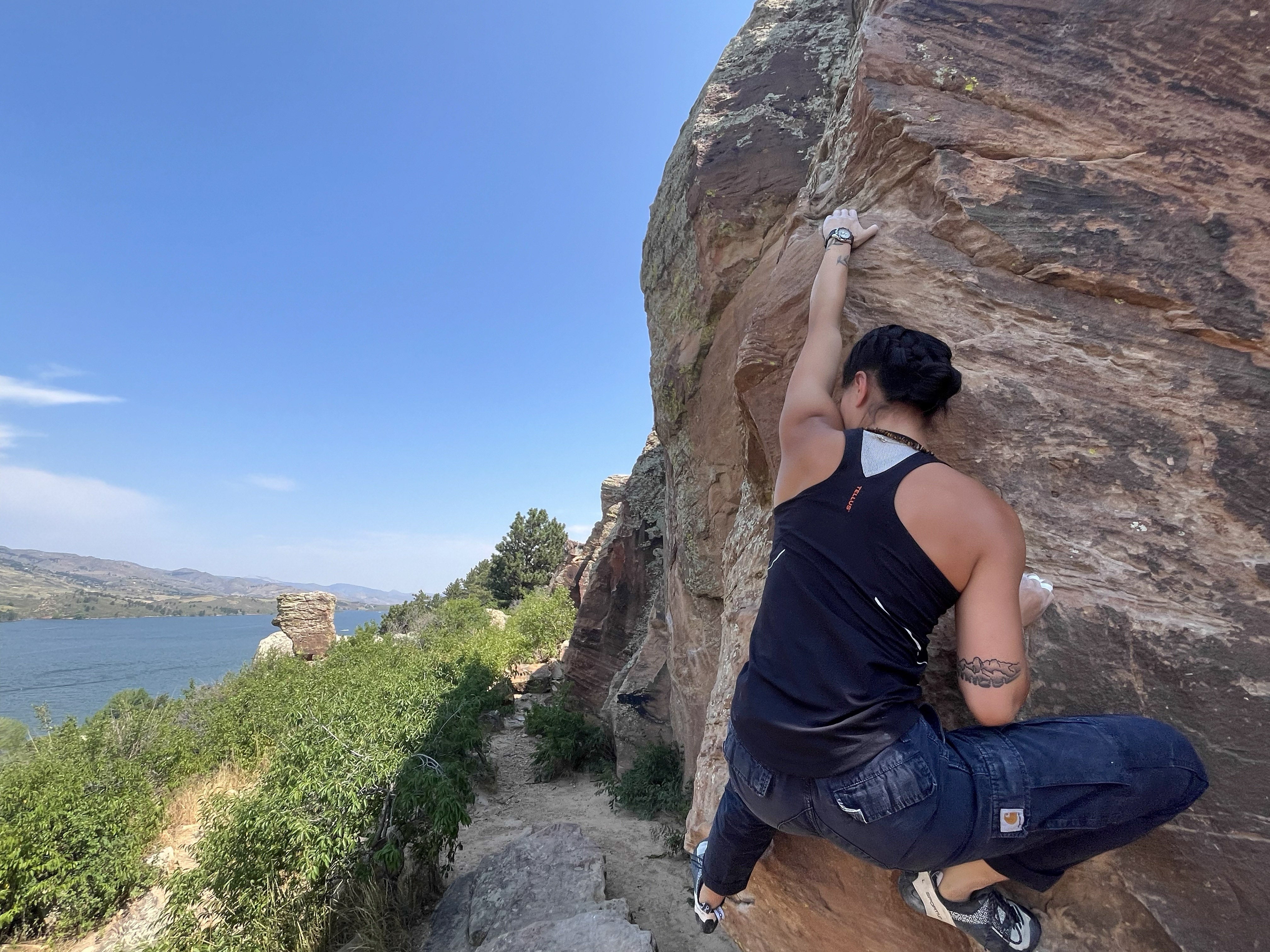 Woman climber wearing Tellus Poudre Trail Performance Tank