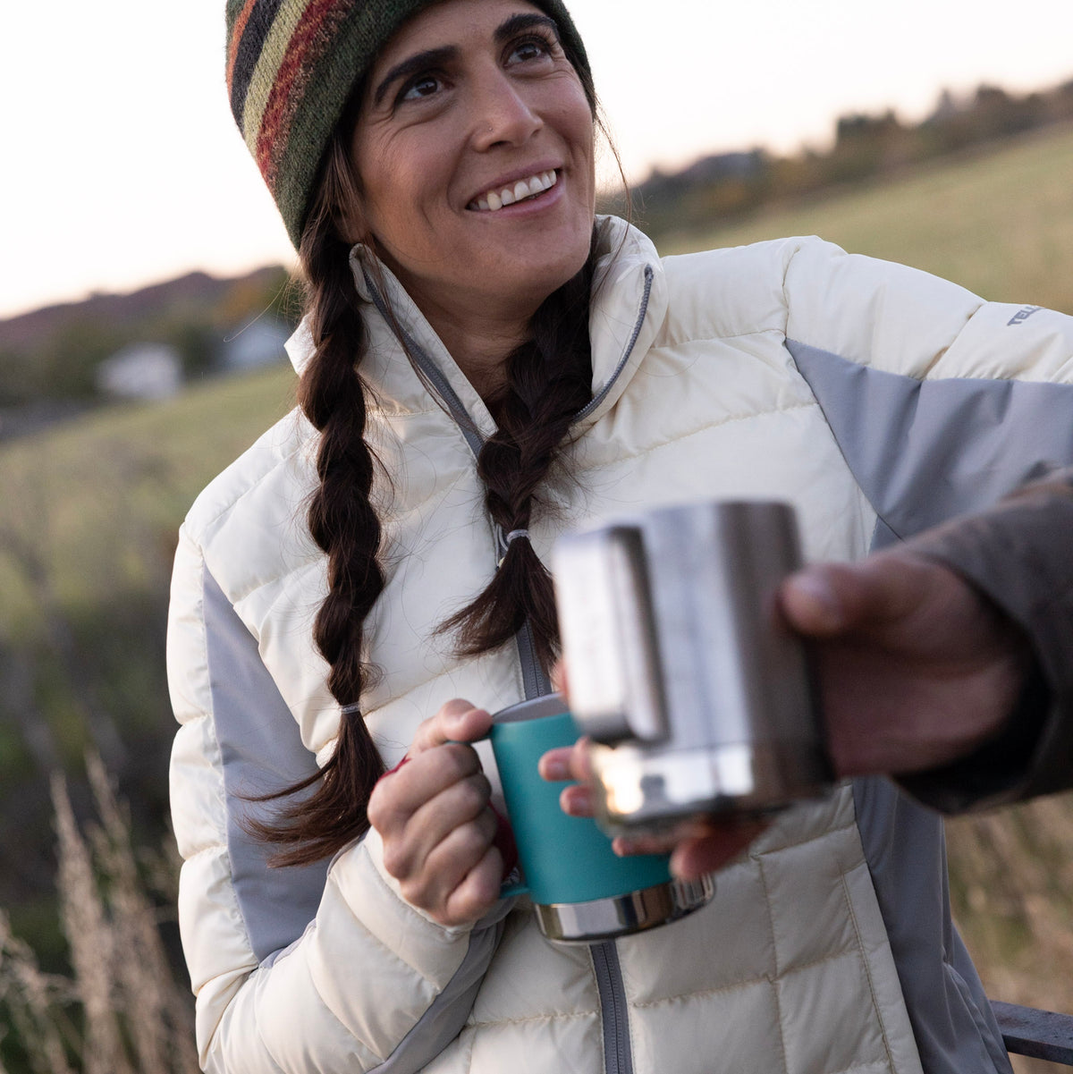 Woman wearing cream Tellus Byers Peak Recycled Down Jacket.